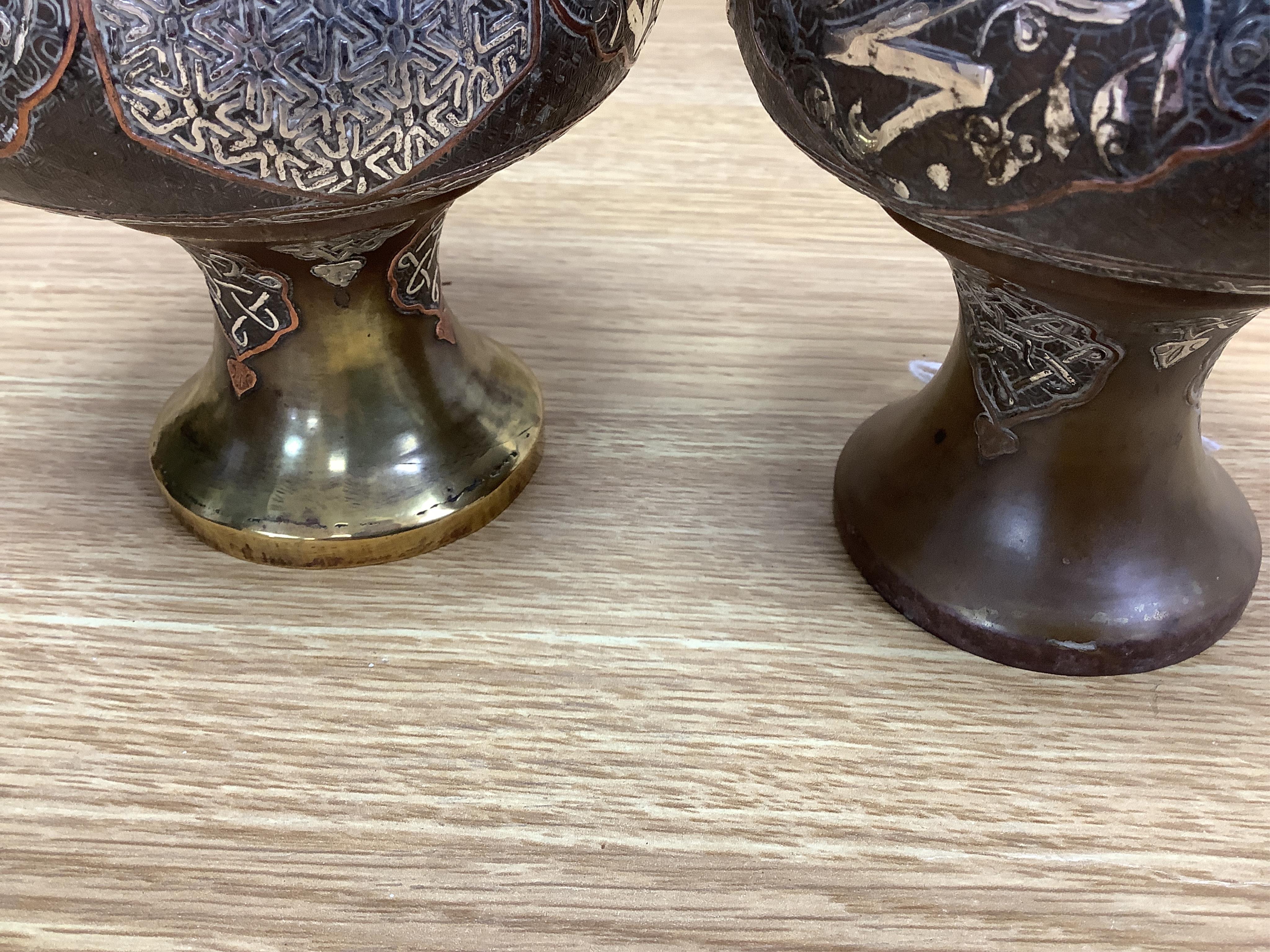 A pair of Cairoware silver and copper inlaid brass vases, 24cm high